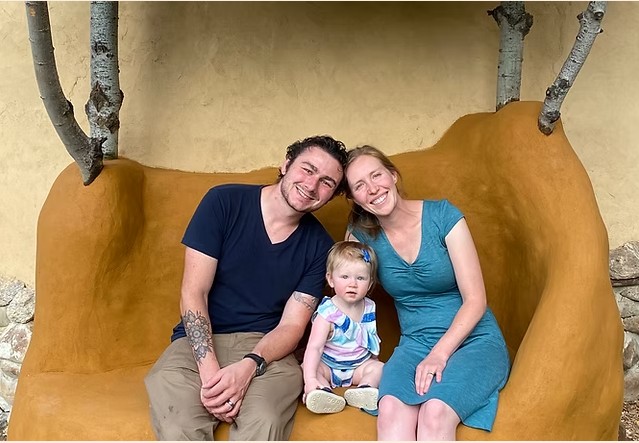 Daniel Ray and his family on a cob bench